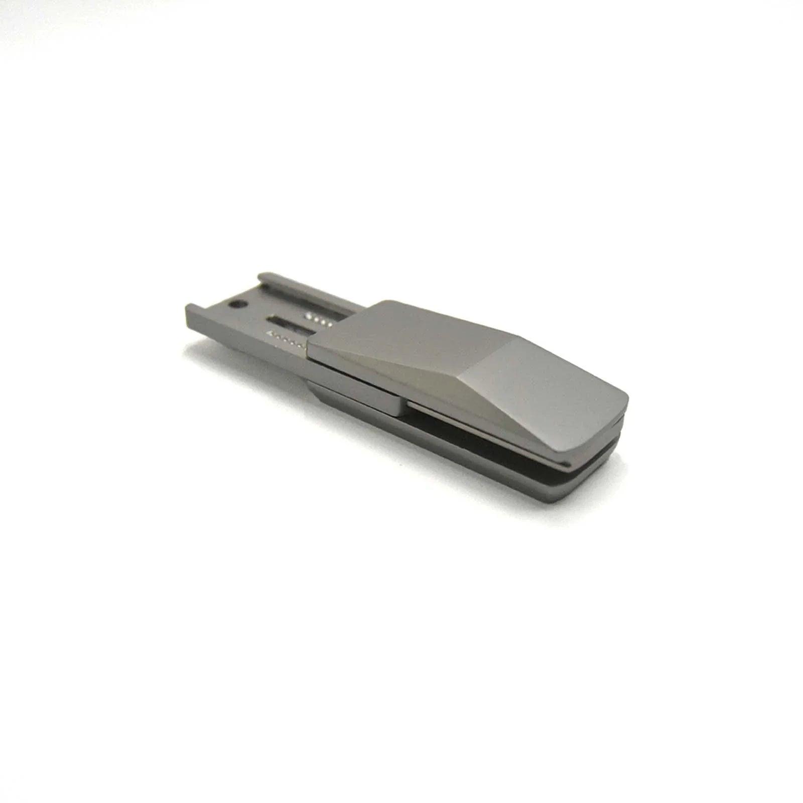 silver-grey metal truck fidget slider for adults, held in hand as a compact metal EDC fidget toy