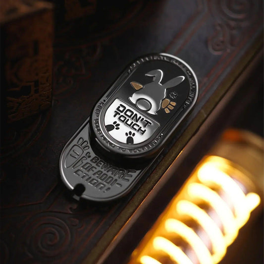 black metal rabbit fidget slider for adults, showing the black finish with white and gold accents